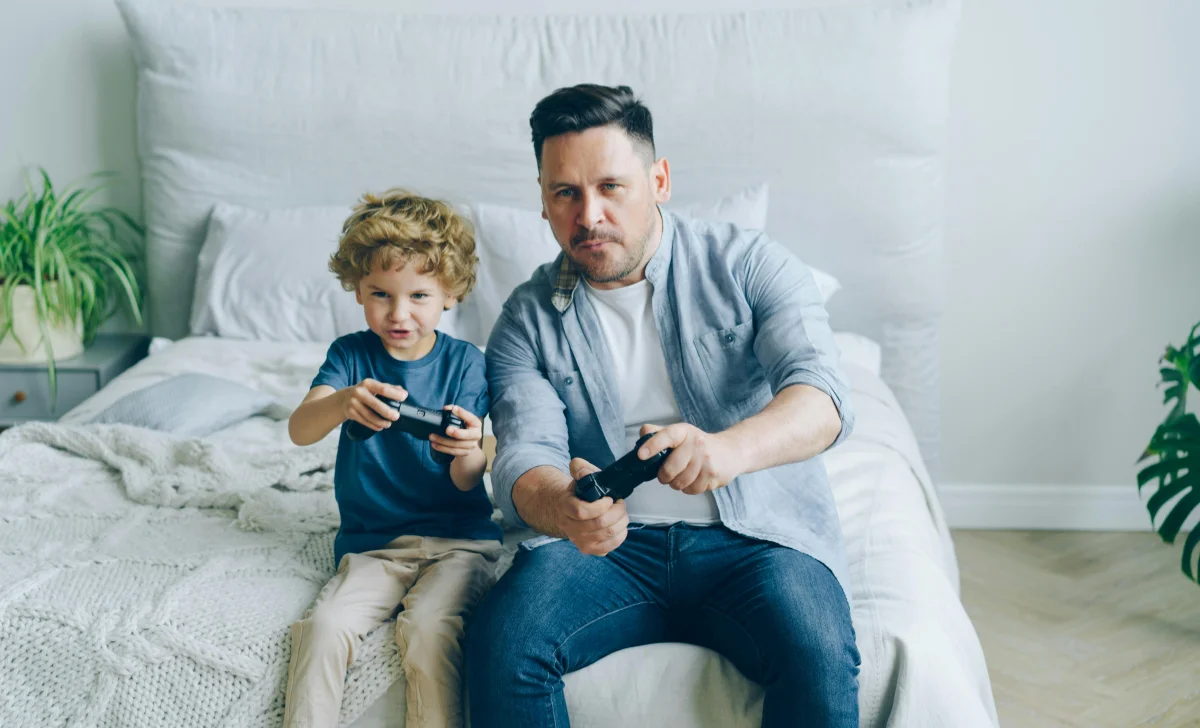 father and son playing video game