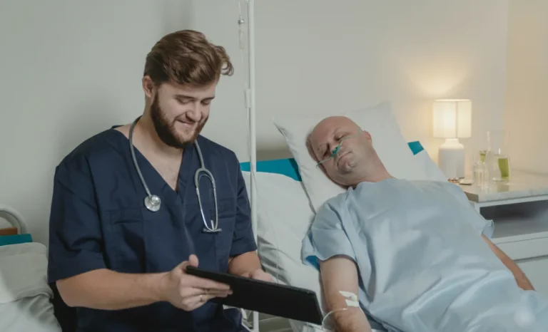 a male nurse sitting near a patient