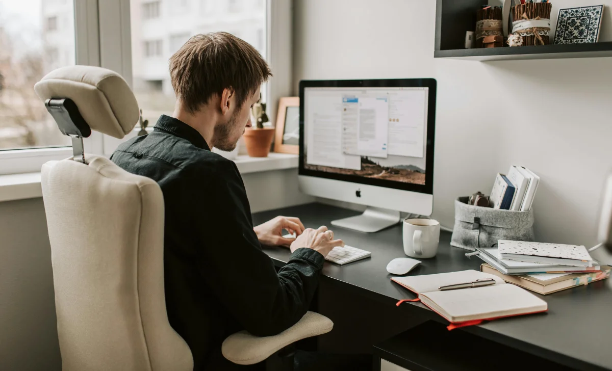 a man using computer in a cozy office
