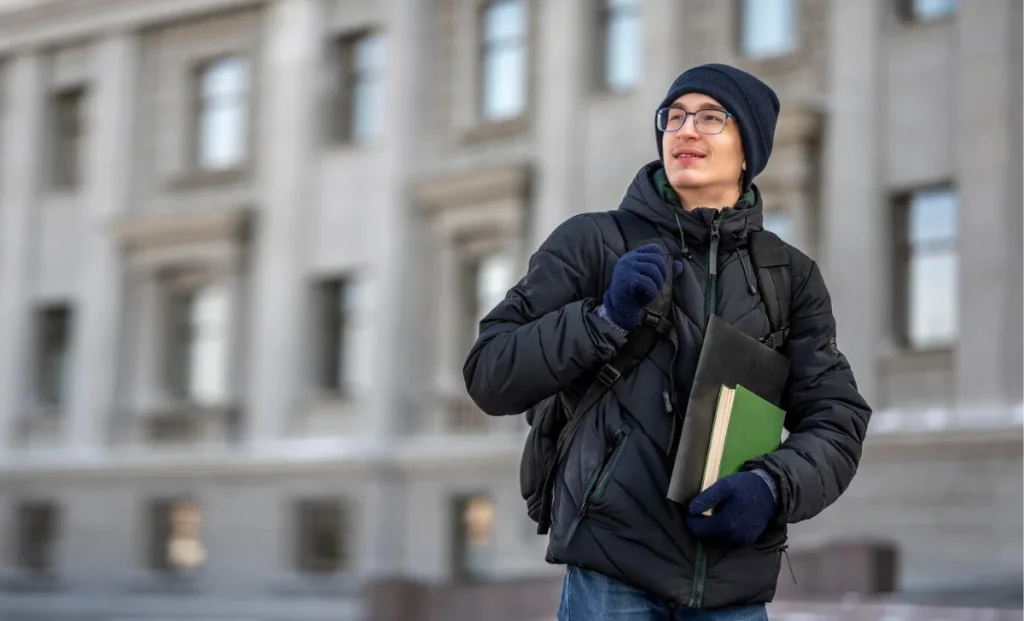 a boy in university holding books in hand