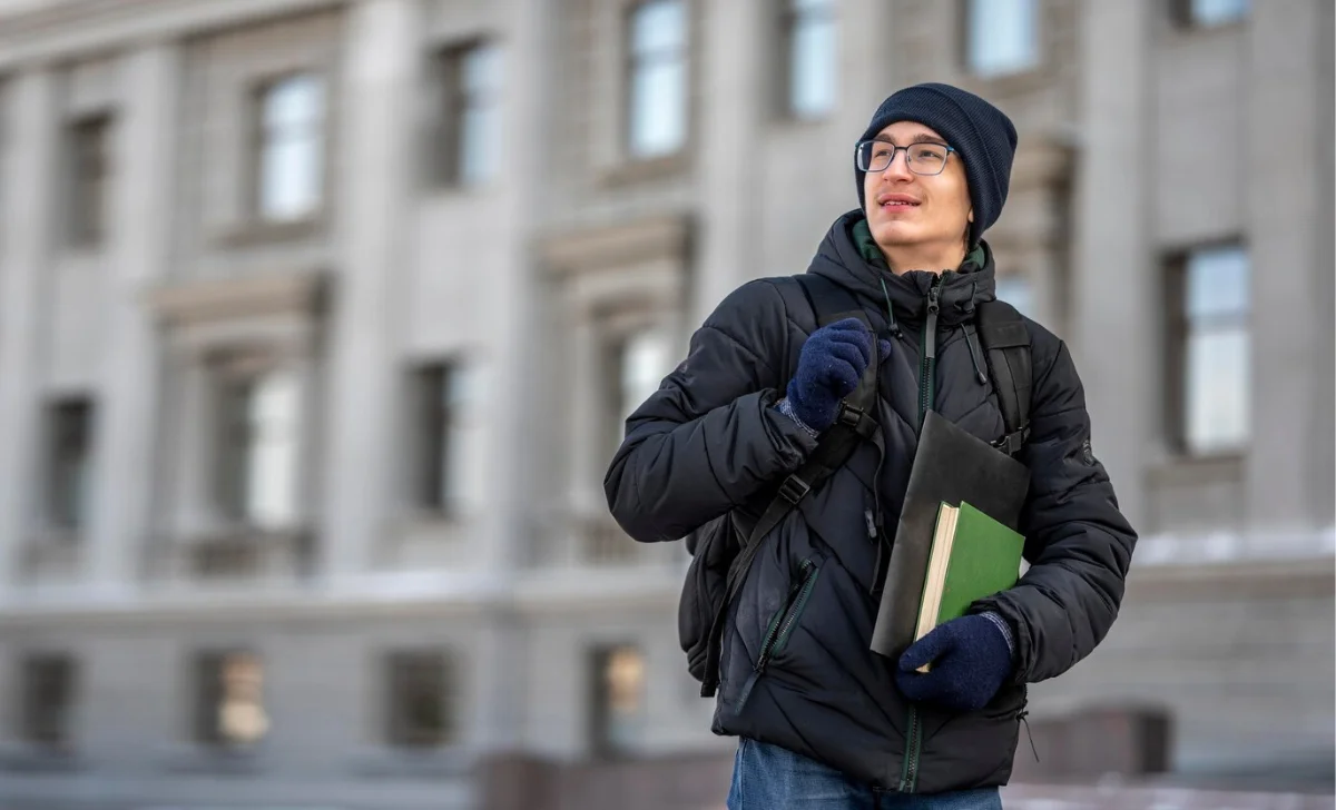 a boy in university holding books in hand