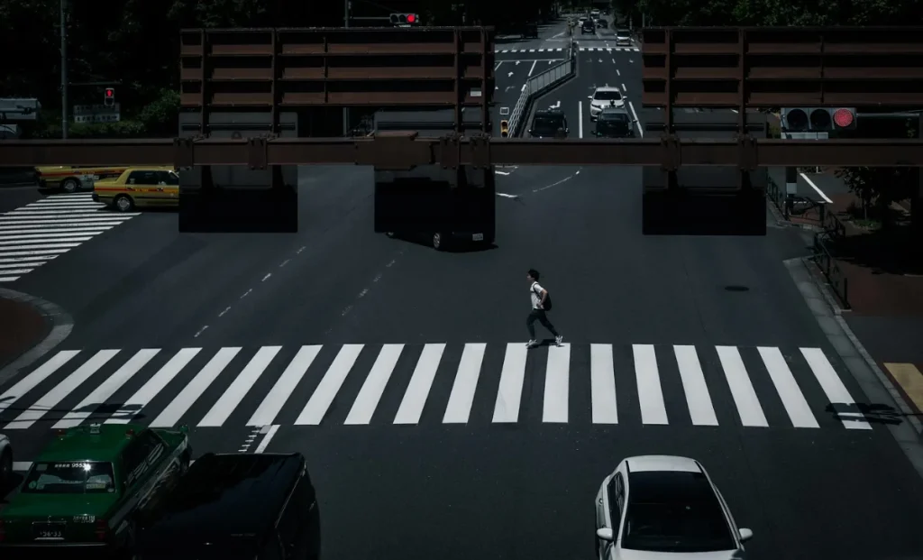 a man walking on pedestrian lane