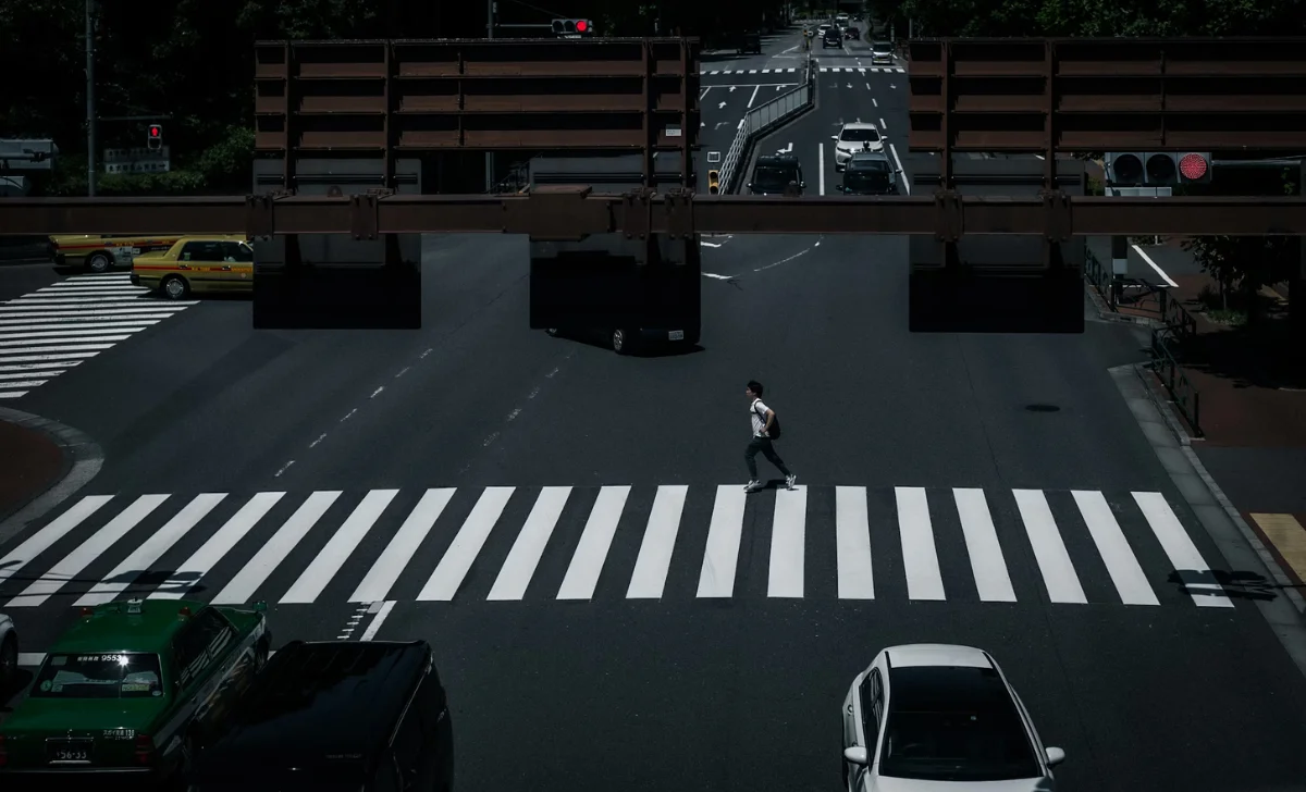 a man walking on pedestrian lane