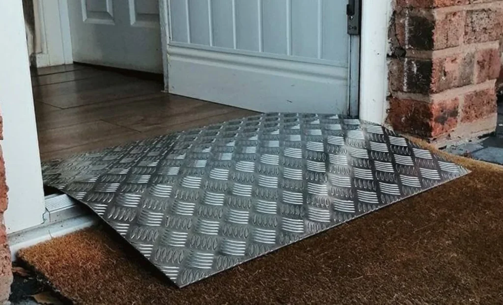 a piece of aluminium checker plate placed in the way of room