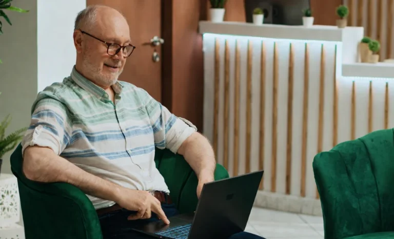 a senior man using laptop