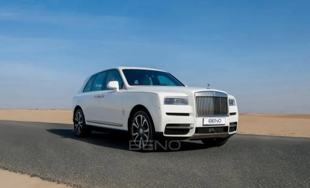 a white rolls royce in desert