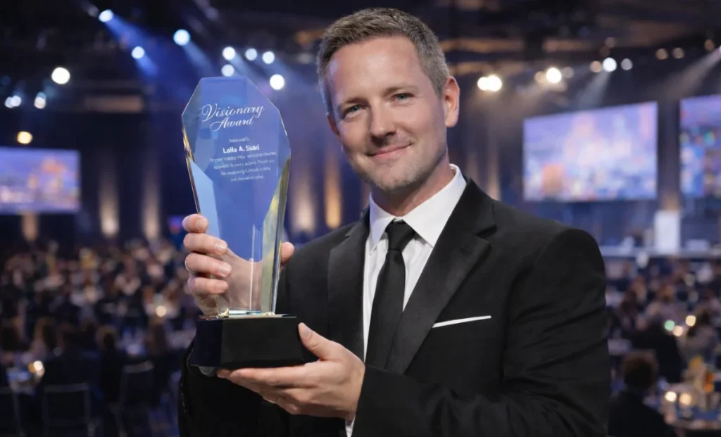 a man holding a glass trophy on stage