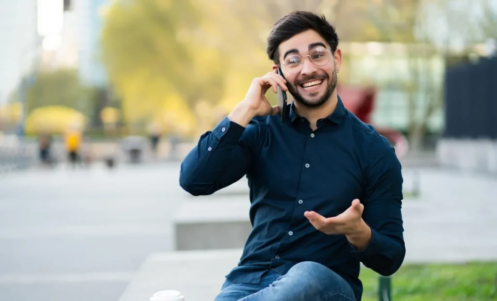 a happy man talking on phone