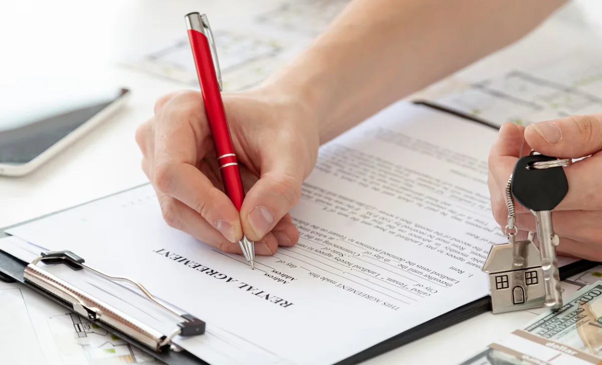 a man signing on a paper for home
