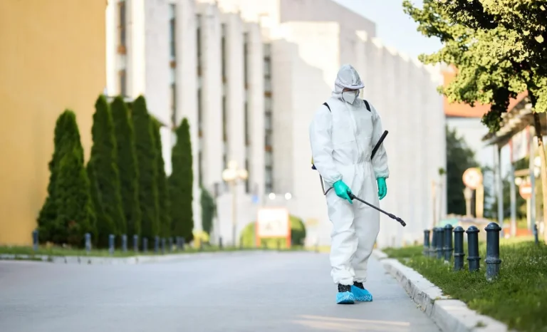 a pest manager man in protective suit