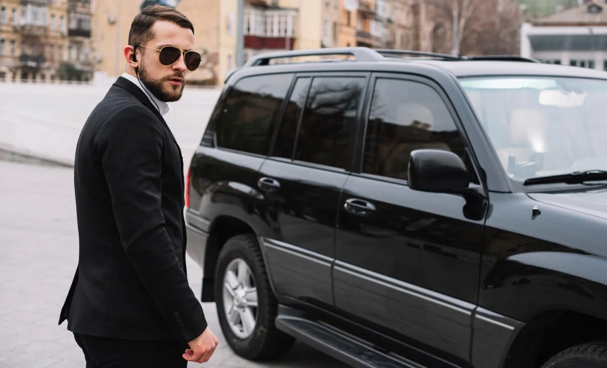a car driver next to black car