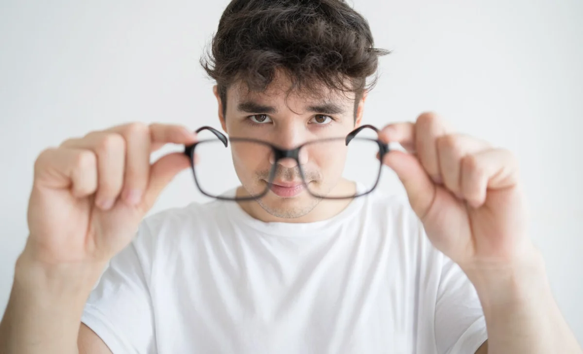 a man holding a glasses