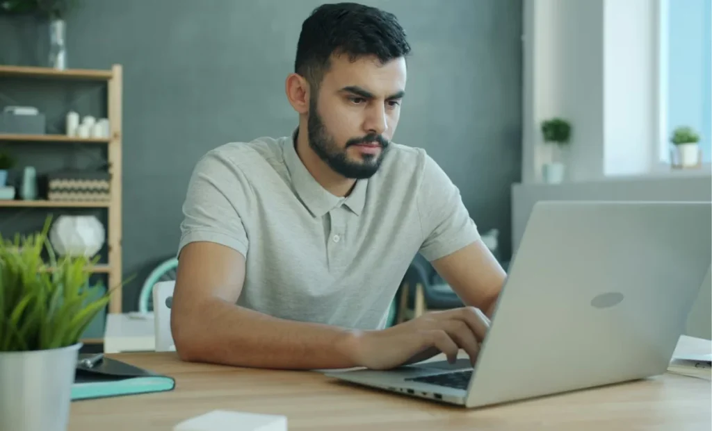 a man using non-branded laptop