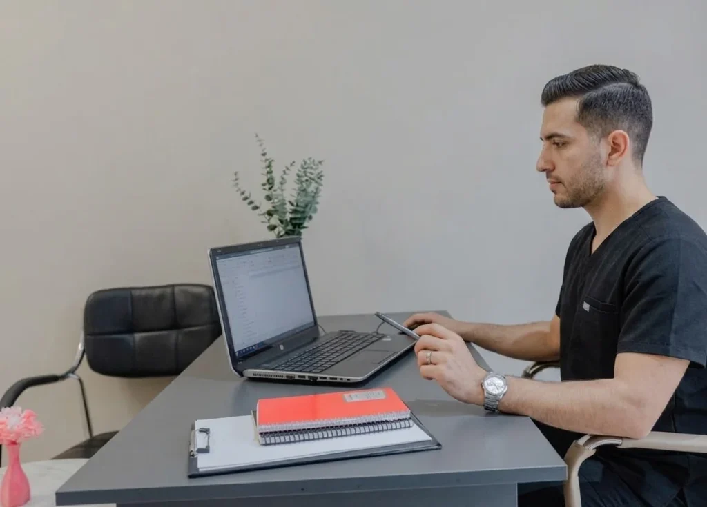a male employee working on laptop