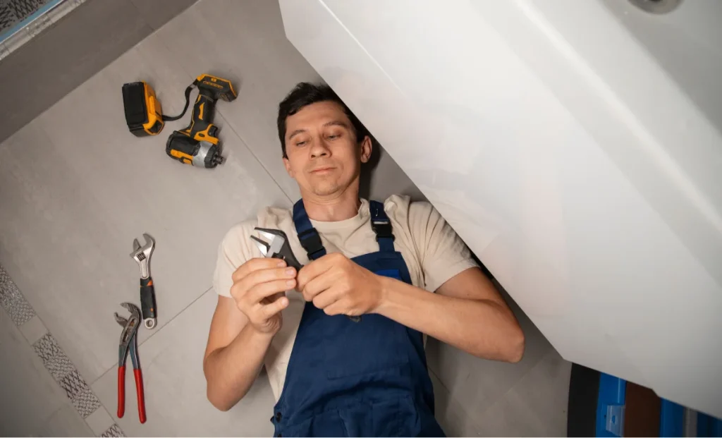 a male plumber adjusting wrench