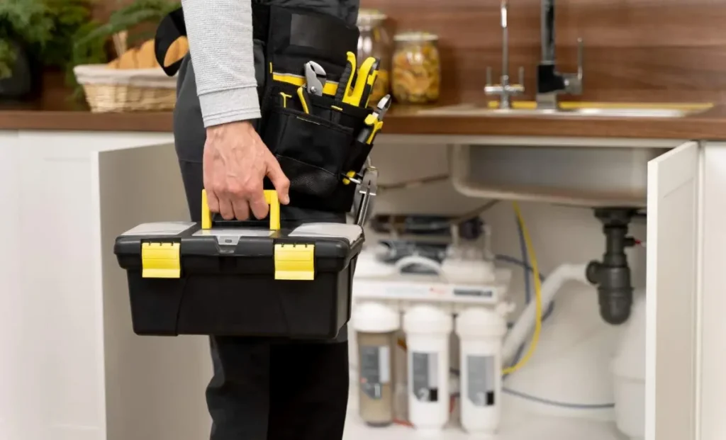 a male plumber with his toolkit