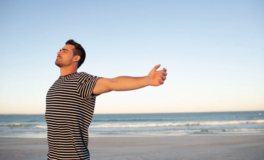 Man standing with arms outstretched