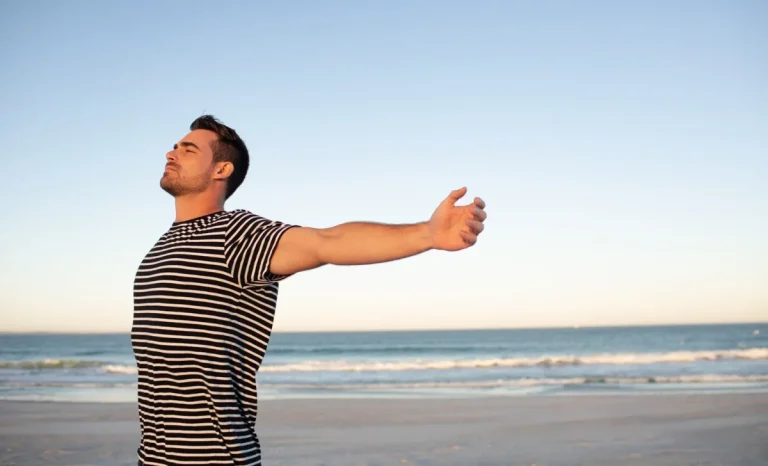 Man standing with arms outstretched