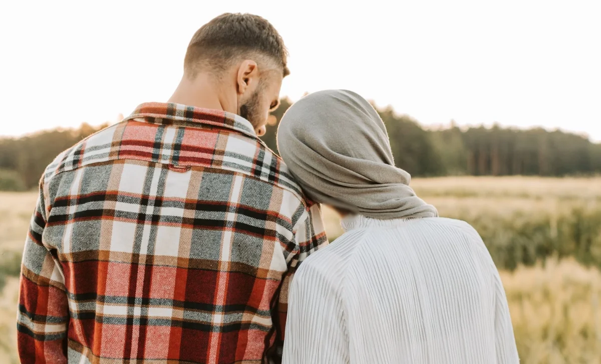 a happy couple in a a field