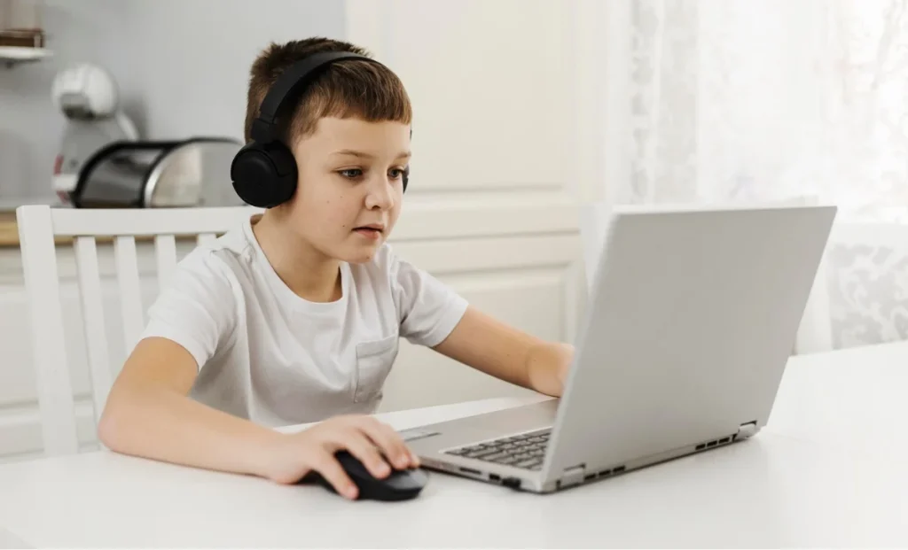 a kid using laptop
