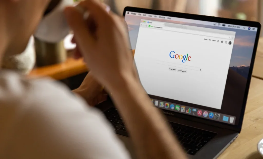a man browsing google while drinking coffee