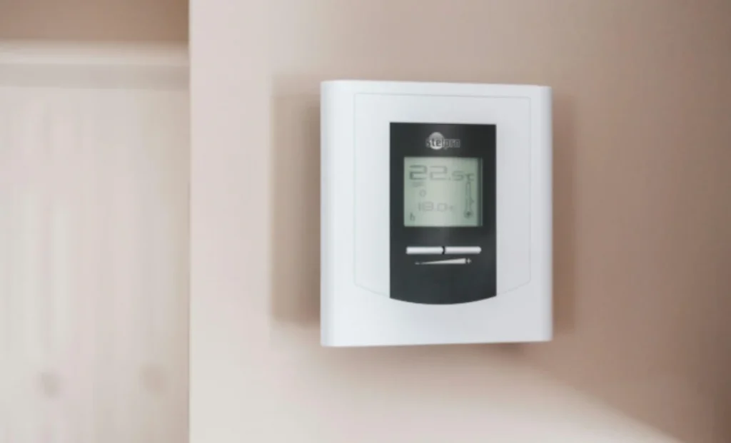 heating and cooling controller mounted on a wall