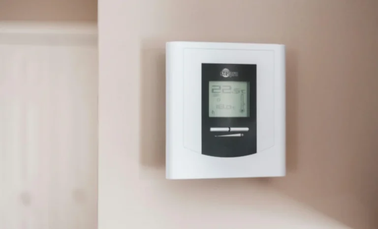 heating and cooling controller mounted on a wall