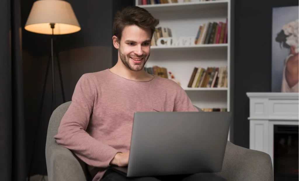 Happy man looking at laptop