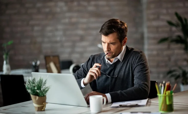 a focused man working on laptop
