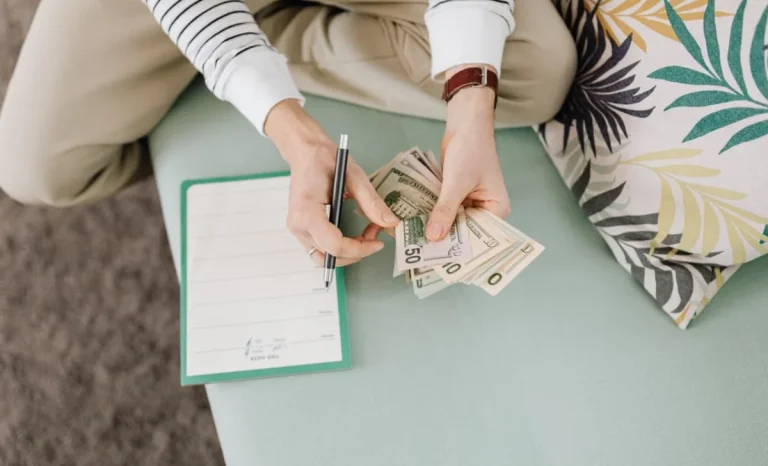 a man counting money on sofa