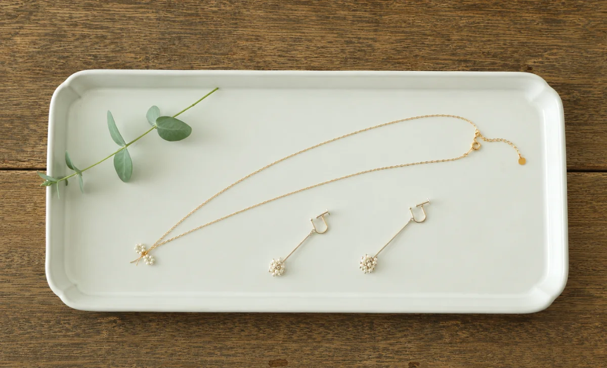 a necklace with two earrings