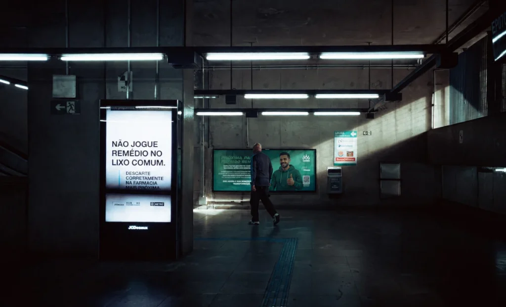 a man walking through walls with advertising screens