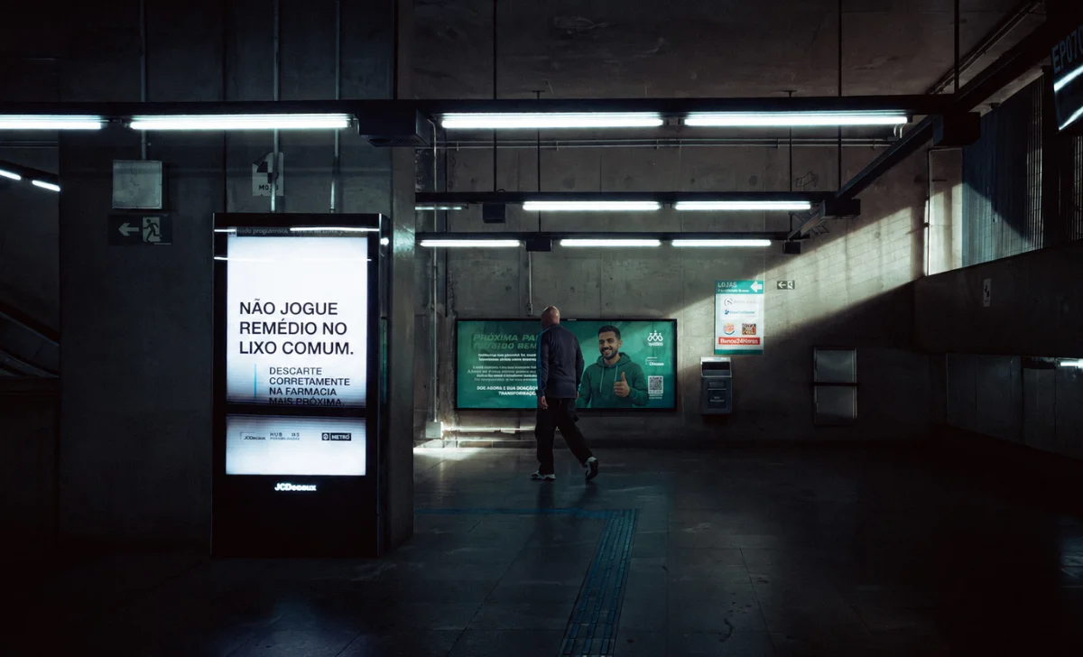 a man walking through walls with advertising screens