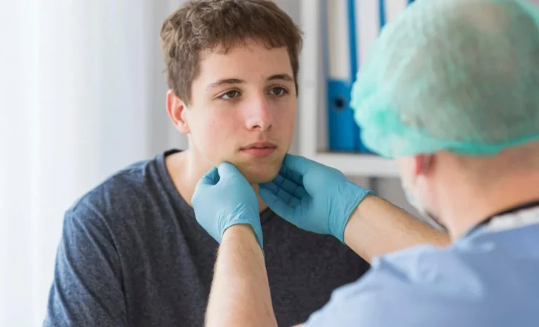 a surgeon checking boy's face for plastic surgery