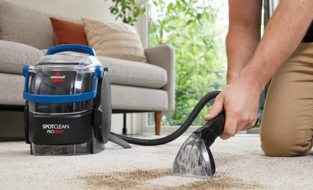 a man using spot cleaner