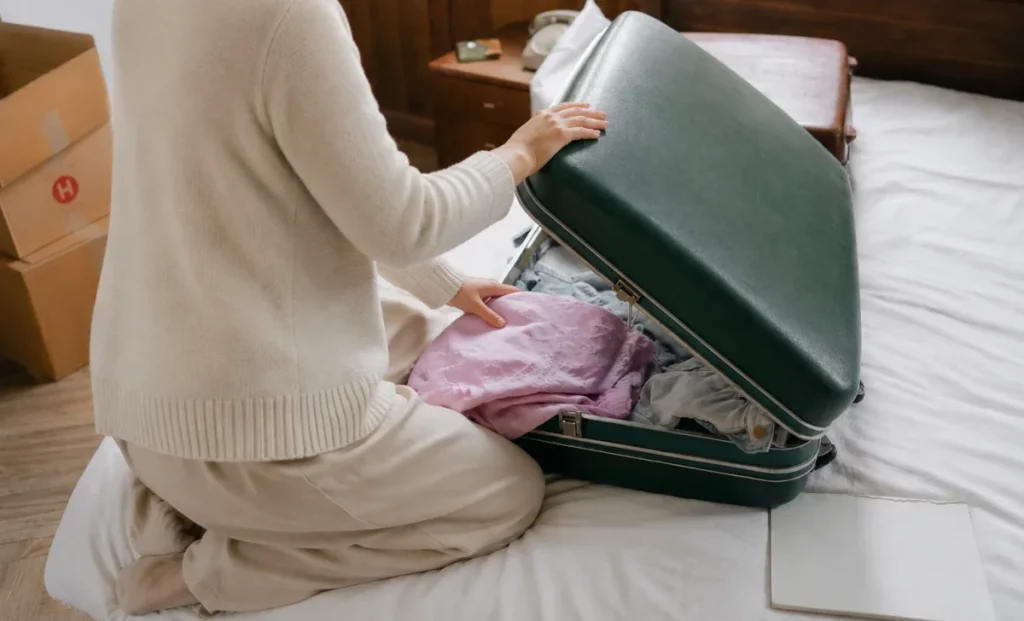 a woman packing bag for trip