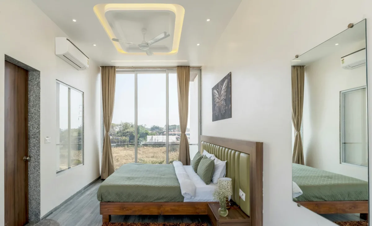 a bedroom with modern ceiling