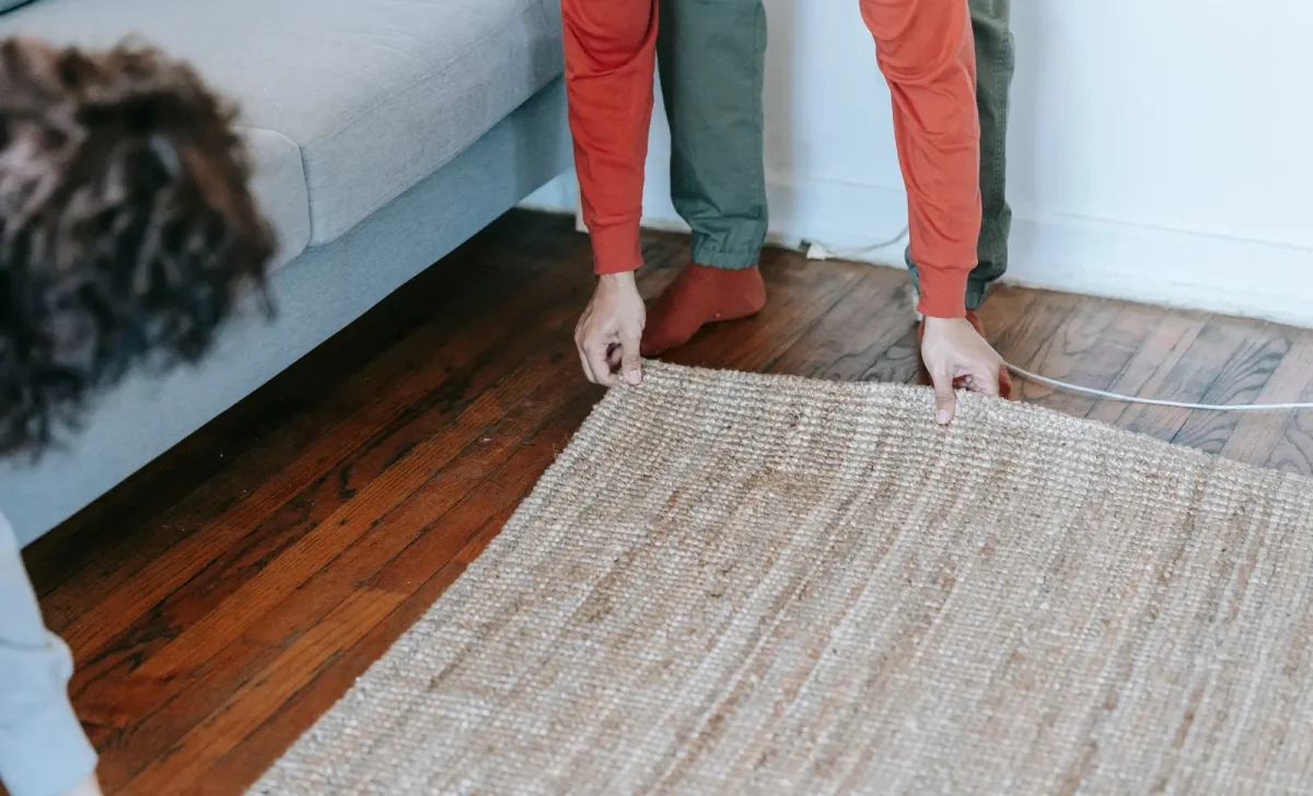 a man adjusting carpet