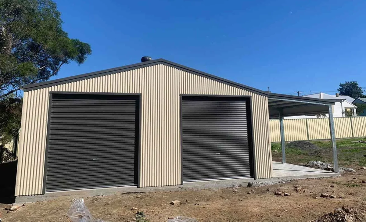 Metal backyard storage shed with two dark roller doors